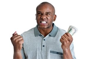 Frustrated man holding a stack of money